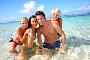 Couple and children in crystal clear water